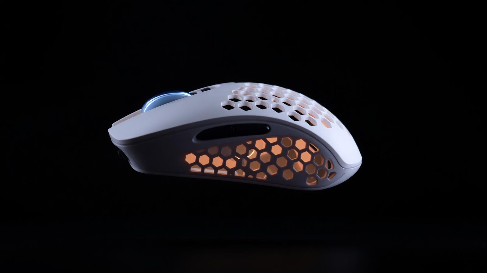 Ultra-light honeycomb wireless gaming mouse photographed on a dark surface